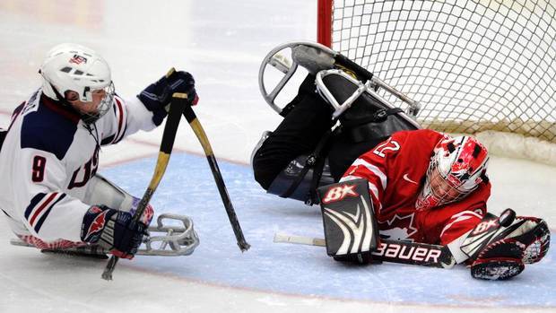 Sledge Hockey - USA Greg Shaw shoots @ Benoît St-Amand of Canada