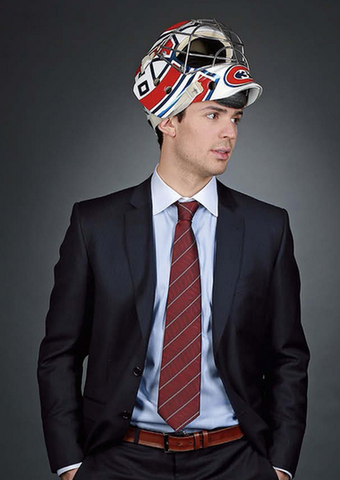 Carey Price in a suit wearing a Goalie Helmet