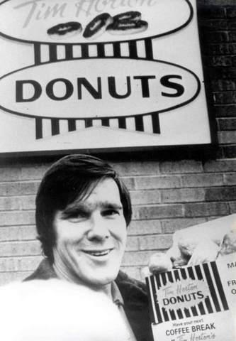 Tim Horton with a box of donuts at Tim Hortons - Early 1970s