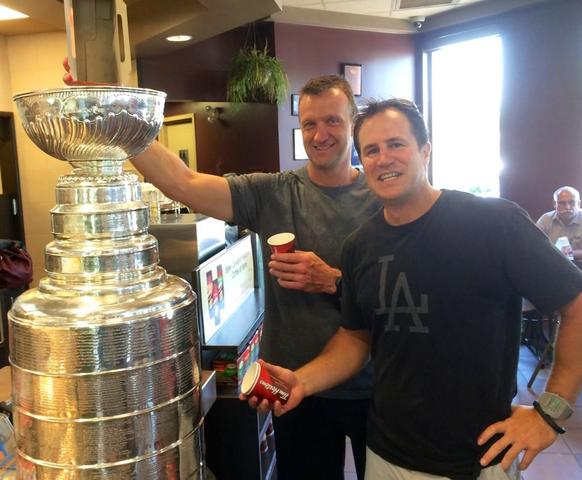 Rob Blake Pouring Timbits into Stanley Cup with Nelson Emerson