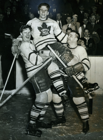 Toronto Maple Leafs Bill Barilko gets lifted by Cal Gardner and Bill Juzda 1951
