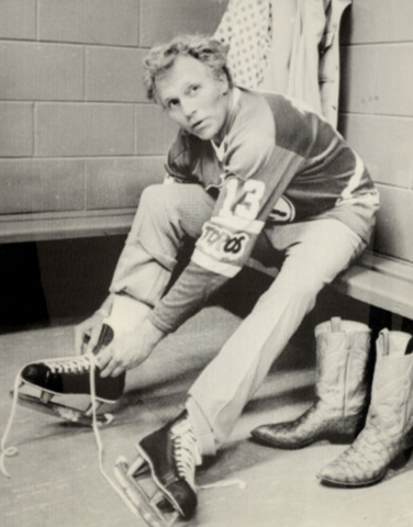 Evel Knievel lacing up his Hockey skates in the Toronto Toros dressing room 1975