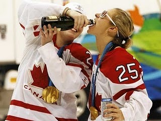 Team Canada Women share a drink on the ice after Winning Gold