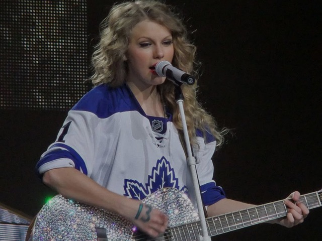 Taylor Swift playing Guitar in a Toronto Maple Leafs Jersey