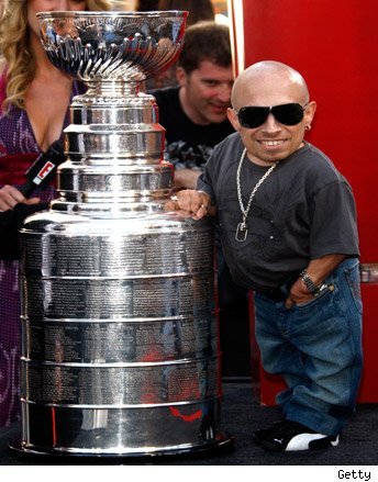 Verne Troyer stands next to The Stanley Cup