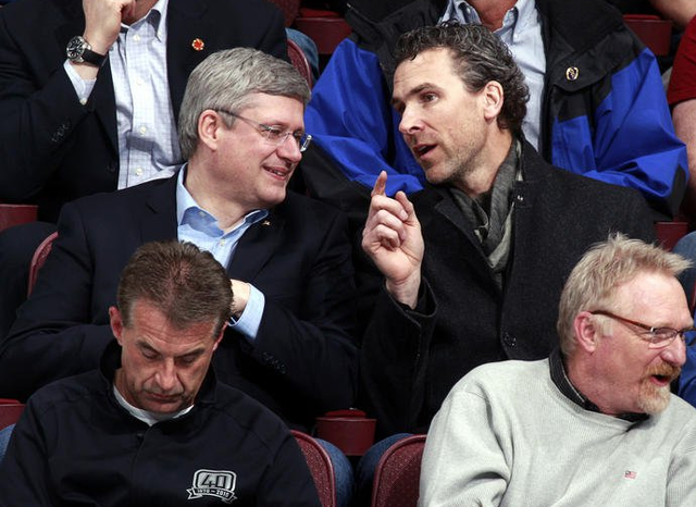 Stephen Harper talks with Trevor Linden at a Canucks Game