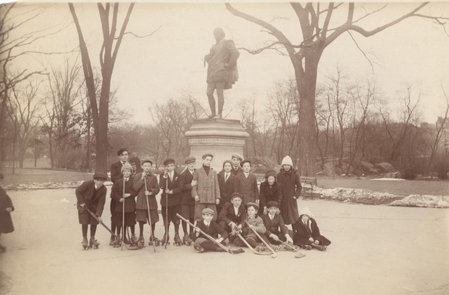 Street Hockey - Young Men Pose For a Group Photo Beside Statue