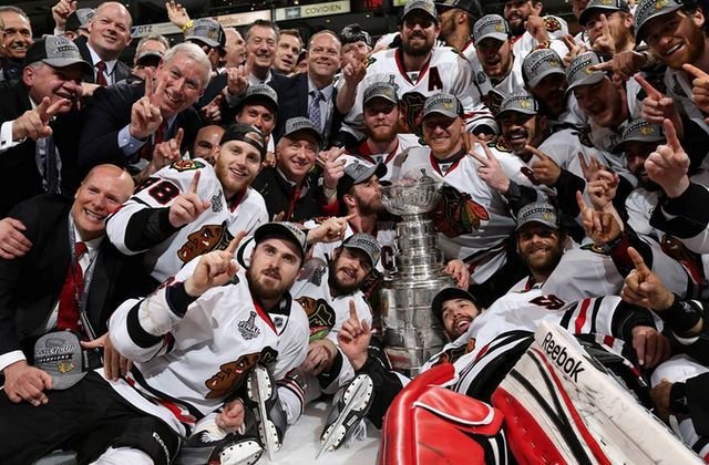 Jonathan Toews Kisses Stanley Cup During Team Championship Photo