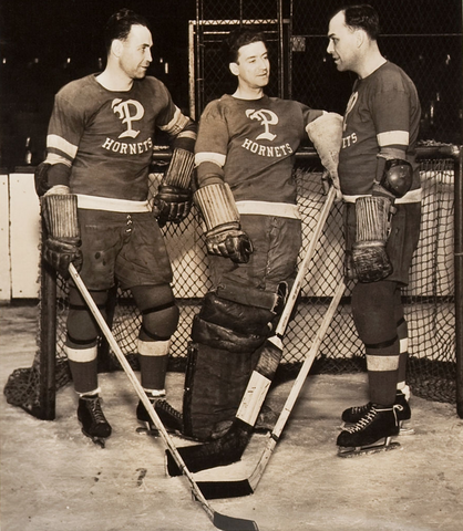 Hap Emms talks with 2 of his Pittsburgh Hornets players - 1938