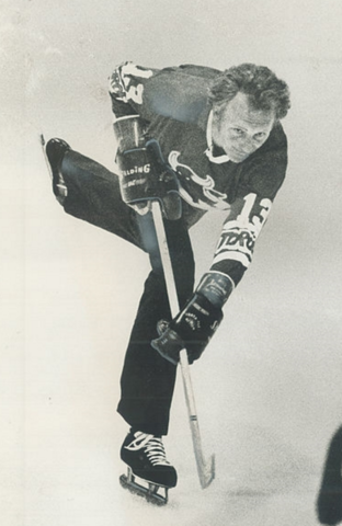 Evel Knievel wears a Toronto Toros #13 jersey & Shoots a Hockey Puck 1975