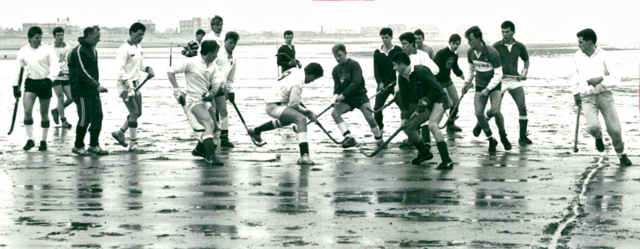 Rossall Hockey on the Beach with Rossall School in background