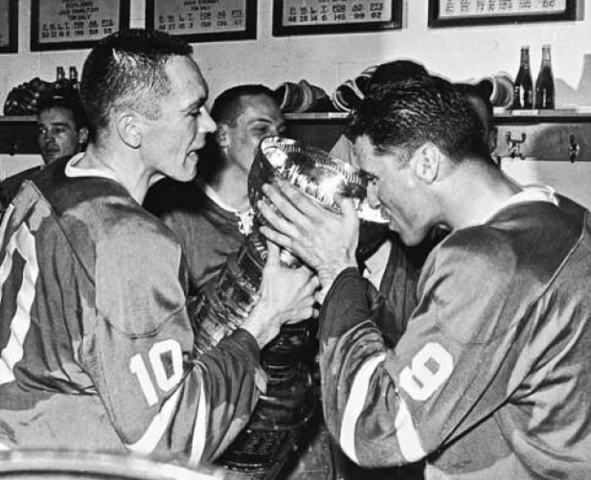 Andy Bathgate drinks from 1964 Stanley Cup, as George Armstrong holds trophy