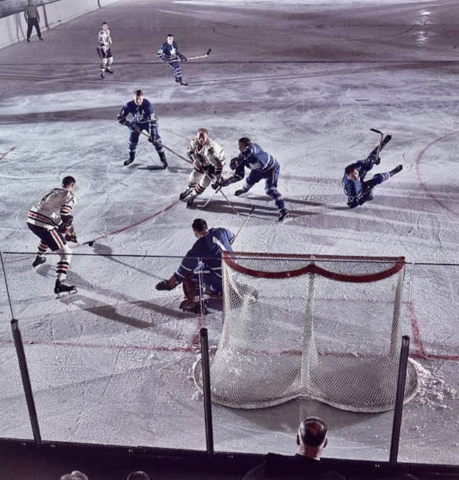 Phil Esposito looks to score on Johnny Bower, while Bobby Hull skates in - 1966