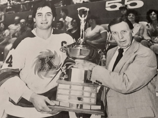 Al Dumba accepts 1980 James Gatschene Trophy from IHL Commissioner Jack Riley