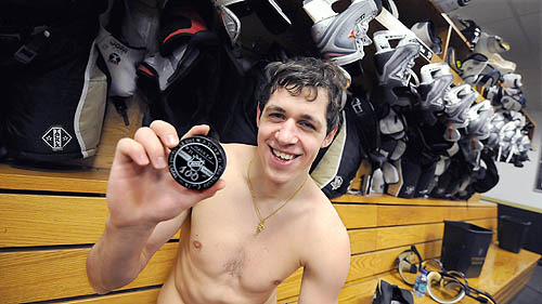 Evgeni Malkin Holds His 1st 100th Point Puck