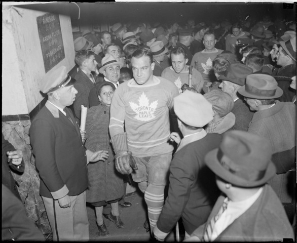 Charlie Conacher  pushing through crowd at Boston Garden - 1936